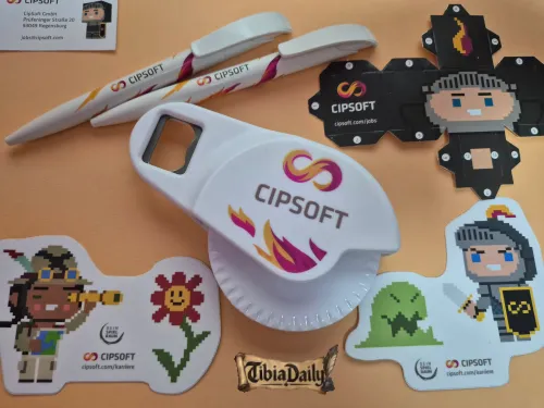 CipSoft pizza cutter with a bottle opener, two pens, Knight and Explorer stickers and a cardboard Knight figure to fold