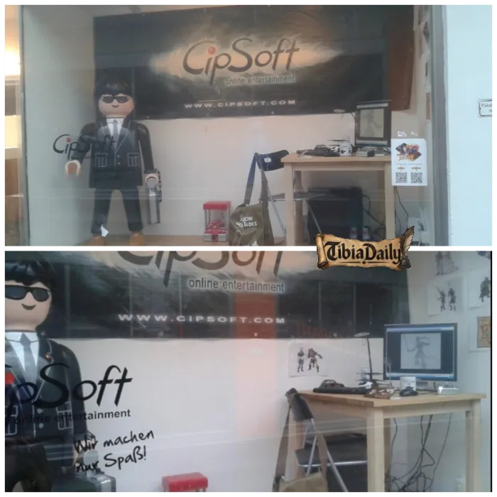 CipSoft shop window at Pustet-Passage with the old logo, a life-size figure in a suit and sunglasses and a desk with a drawing monitor